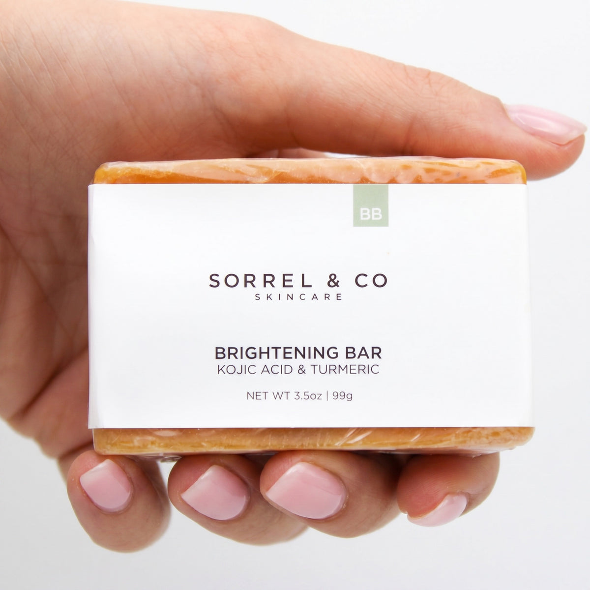 Brightening Bar with Kojic Acid & Turmeric held in hand