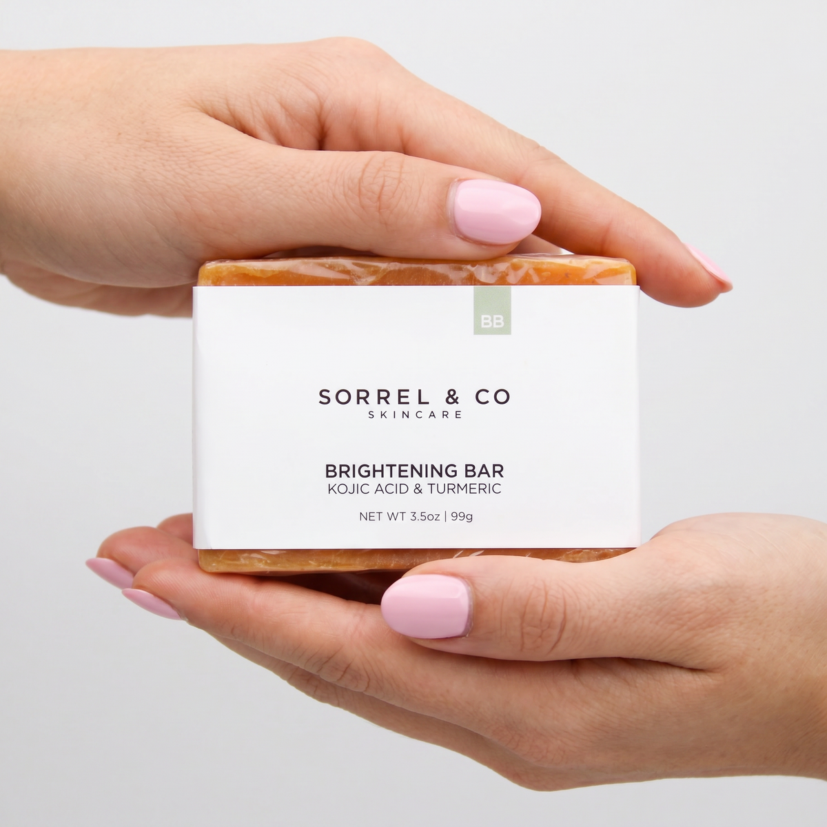 Brightening Bar with Kojic Acid & Turmeric held in hand