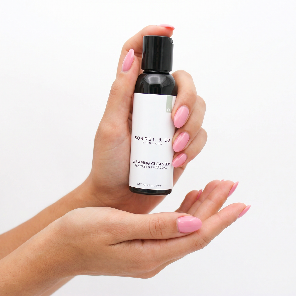 Clearing Cleanser with Tea Tree & Charcoal held in hand