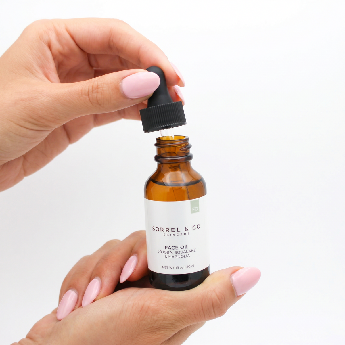 Face Oil with Jojoba, Squalane & Magnolia held in hand