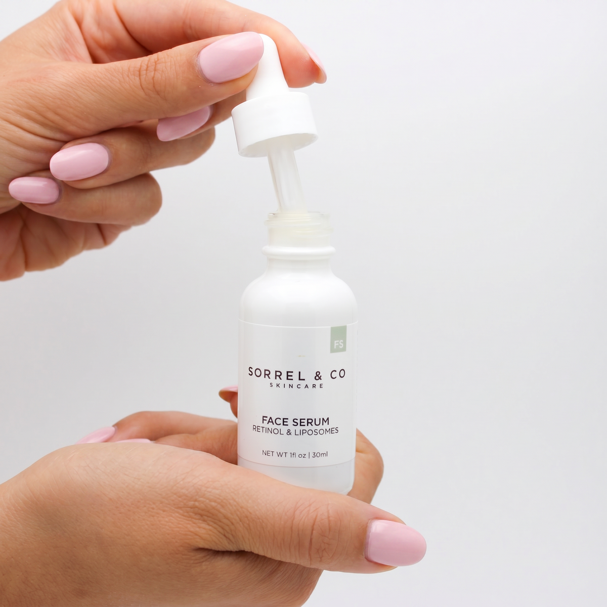 Face Serum with Retinol & Liposomes held in hand