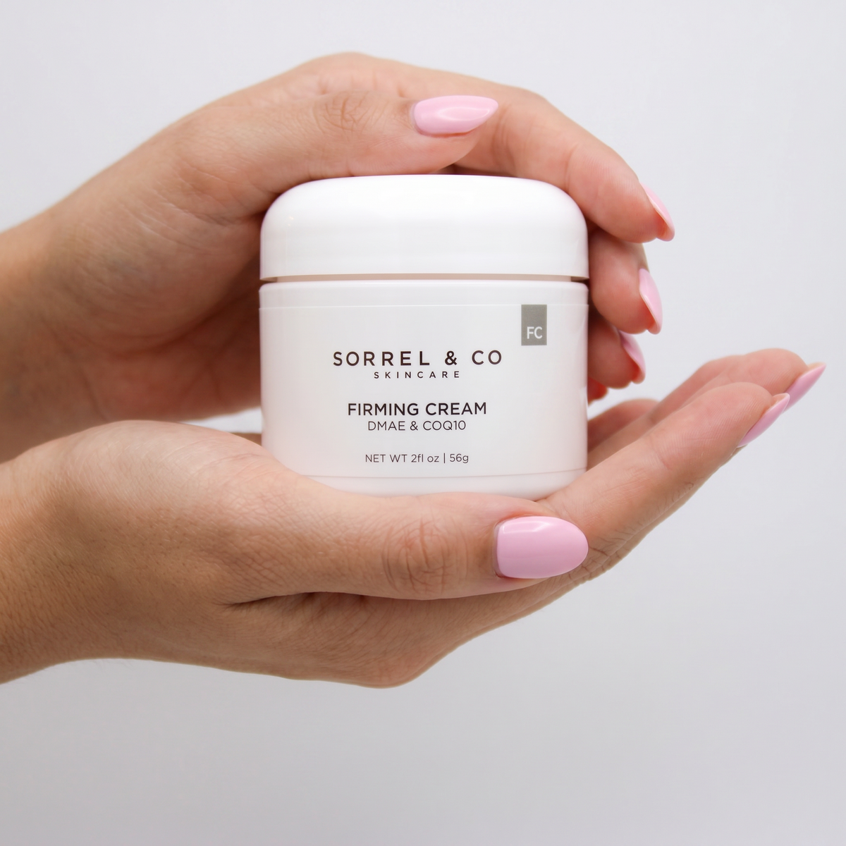 Firming Cream with DMAE & CoQ10 held in hand