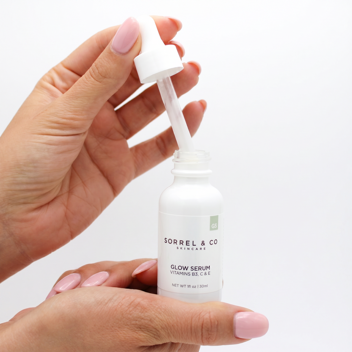 Glow Serum with Vitamins B3, C & E held in hand