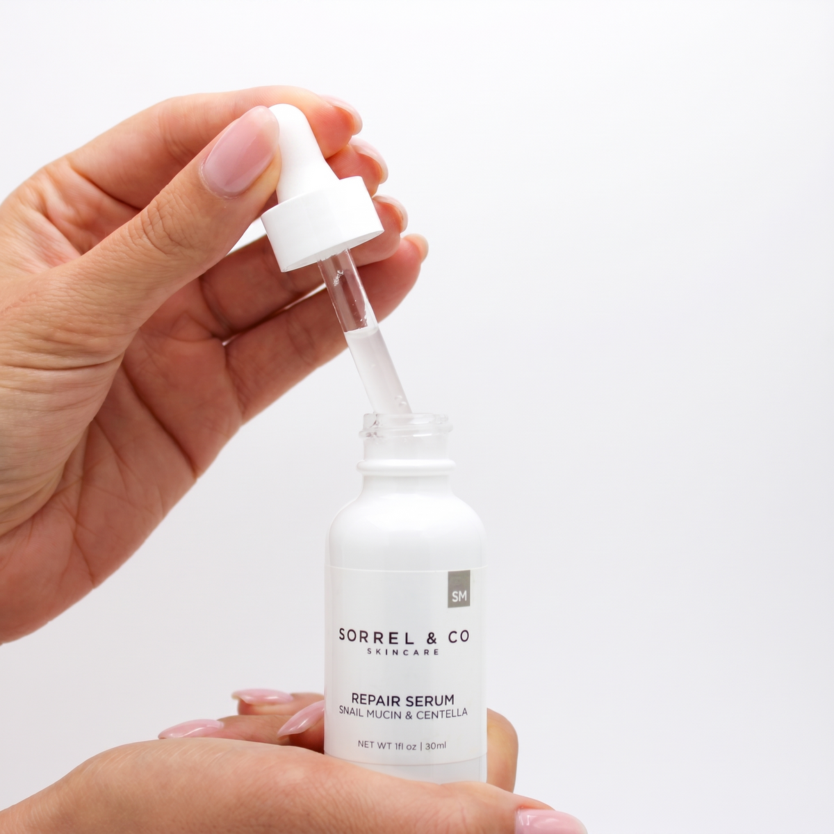 Repair Serum with Snail Mucin & Centella held in hand